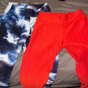 2 pairs of leggings one pair is plain red and the other pair is Ty dye